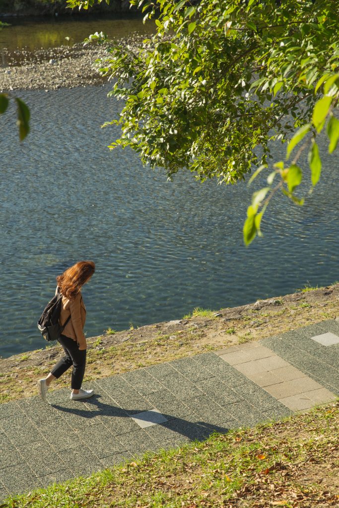Person walking next to a river
