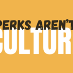 Orange poster with large white block text partially obscured by a distressed black headline reading “PERKS ARENT” across the center. The design emphasizes the bold contrast between white and black typography.